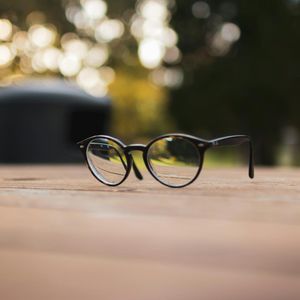 Close-up of a glass of water and incense.